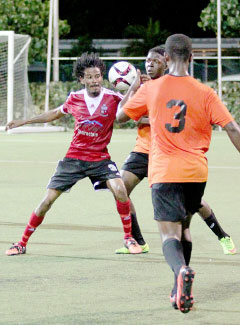 Kevin Moore battles for the ball against Roma defenders on Sunday. – PHOTO: RON SHILLINGFORD