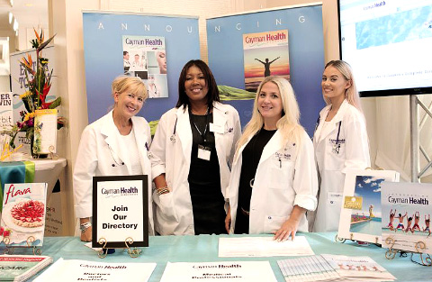 Staff members from Pinnacle Media, bedecked in medical whites, offer a preview of Cayman Health Directory and Cayman Health Magazine, both of which will debut in 2016.