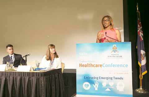 Athlete Cydonie Mothersill, at podium, talks about the stem cell treatment she underwent