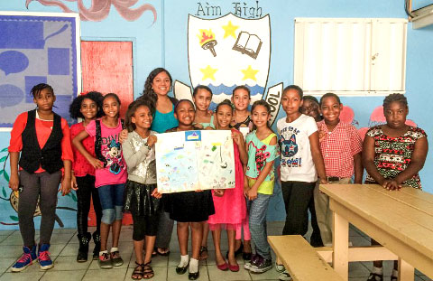 Members of teacher Desiree Powery-Tatum’s Year 5 class show off the winning poster depicting threats to Cayman’s reefs.