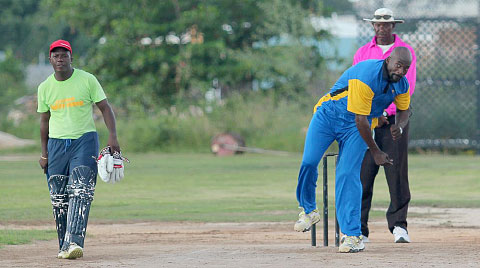 Ryan Bovell bowls for Barbados as batsman Alister Ifill looks on.