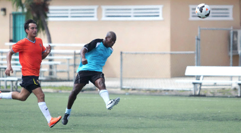 Keamille Mighty hits the second of his three for Boca as Antonio Rodriguez looks on. - PHOTOS: RON SHILLINGFORD