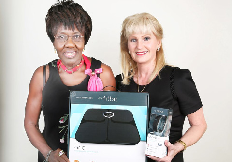 Mrs. Petgrave is presented with her prize by Cayman Health publisher Vicki Legge.