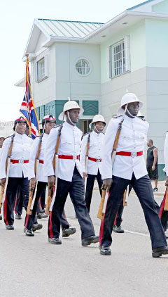 A detachment of the Royal Cayman Islands Police Service parades through downtown George Town.