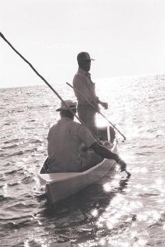 Two unidentified fishermen in a motorless boat use their ‘push stick’ along the shallows of Frank Sound at sunrise in this photo taken in the late 1970’s. - Photo: George Nowak