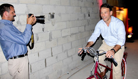 Pedal Power: Kimpton CEO Mike DeFrino takes a spin on one of the hotel’s signature guest bikes at a launch event Wednesday.