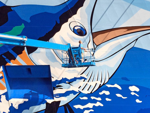 Eye to eye: Guy Harvey checks out his work. - PHOTO: COURTESY GUY HARVEY