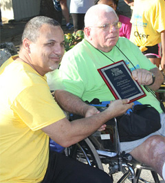 Franz Manderson presents coach Jerry Harper with an award.