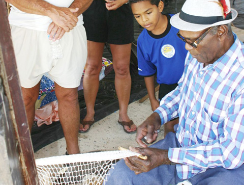 Jerlow Rankine demonstrates fishing skills at a prior East End Heritage Day.