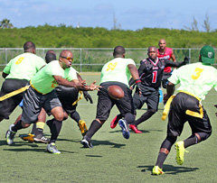 Jayson Clarke hands off to a receiver for the Bahamas. - PHOTOS: RON SHILLINGFORD
