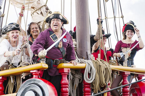 Avast, me hearties! Pirates aboard the Jolly Roger ship get ready to land at Hog Sty Bay. – PHOTO: TANEOS RAMSAY