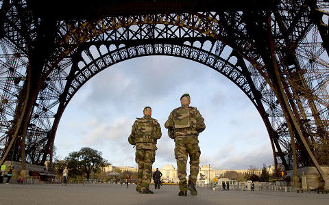 French soldiers patrol Sunday at the Eiffel Tower, which remained closed on the first of three days of national mourning in Paris. – PHOTO: AP