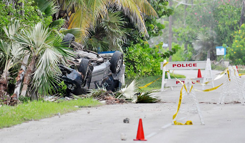 The Honda Odyssey van overturned along South Side Road East in Cayman Brac, killing two of the three men inside. - Photo: Ed Beaty