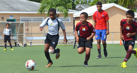 Action in the Red Bay versus Cayman Brac Under-11 game.