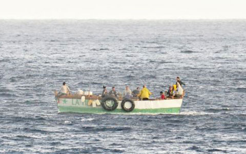 A ramshackle boat, believed to be carrying Cuban migrants, was spotted off the Brac on Wednesday. – PHOTO: ED BEATY