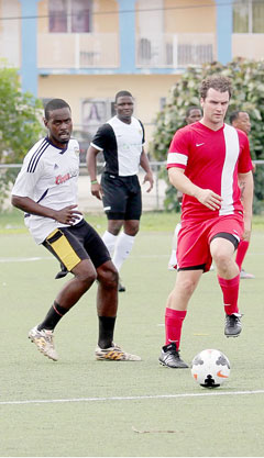 Alwin Brooks, left, scored the only goal of the game against Maples for Wanderers.