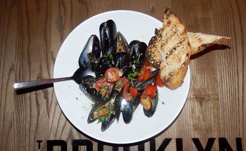 The steamed mussels, with shallots, cherry tomatoes, garlic, white wine and garlic toast are a must.