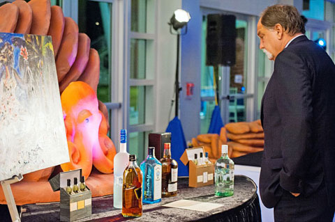 Keith Sahm seems particularly interested in certain auction items. - Photo: Courtney Platt