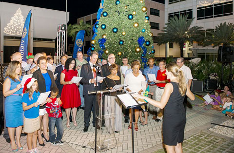 Rotarians, supported by Premier Alden McLaughlin and other members of the government, sing Christmas carols Thursday evening as part of Rotary’s annual Christmas tree lighting celebration.
