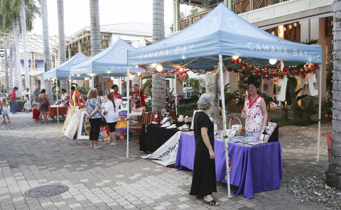 Visitors browse a holiday craft market at Camana Bay. - Photo: Stephen Clarke.