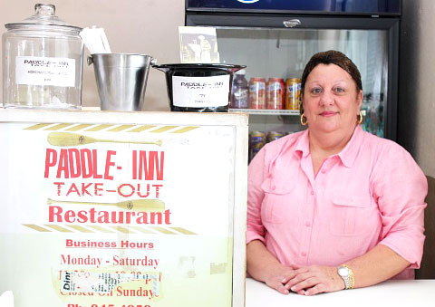 Lorriane Ebanks mans the counter at the Paddle Inn. - Photo: Jewel Levy