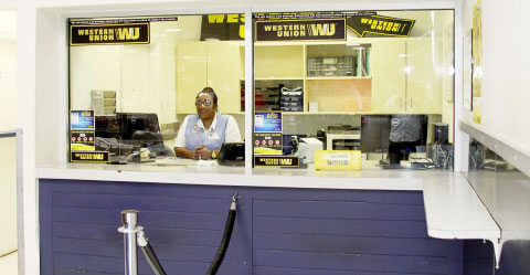 Leisa Thompson-Garric mans the newly reopened Western Union counter at Foster