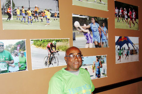 Compass sports editor Ron Shillingford with a small sample of the photos he has taken over the years. - PHOTOS: JAMES WHITTAKER