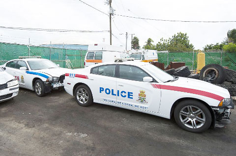 Police vehicles are parked at the government