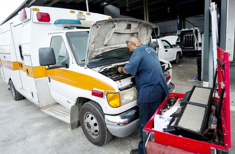 A mechanic works on the engine of a Health Services Authority ambulance at the government’s Department of Vehicle and Equipment Services. - PHOTO: TANEOS RAMSAY
