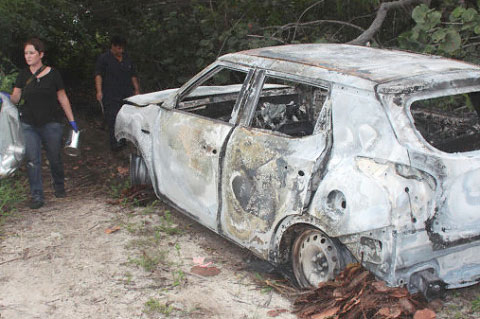 The burned-out car was removed by police from a dirt track off Frank Sound Road. – Photo: Jewel Levy