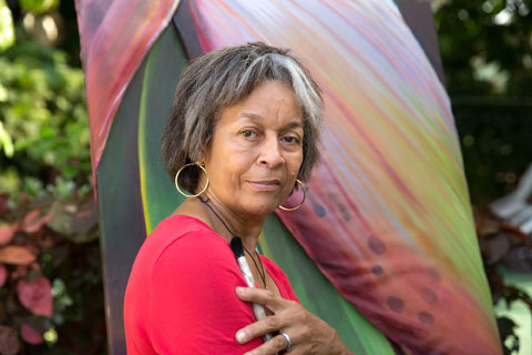 The artist, Maureen Lazarus, with paintbrush in hand.