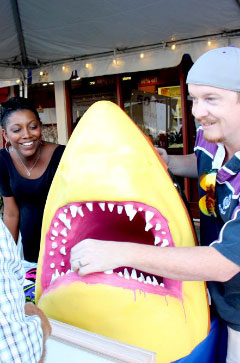 Smile: Marc and Pam Laurenson show off their spray-painted shark, a mascot for their pop-art group Stoak’d.