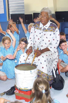 Julia Hydes plays her iconic home-made drum for young fans in 2005.