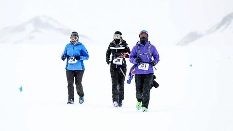 Lisa Colon Richardson from the U.S., Sasie Smittipatana from Thailand, and Teresa Strad from Cayman muster the mental and physical energy to get them through freezing, white-out conditions.