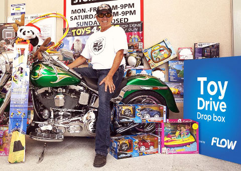 Casey Keller, a member of the Cayman Islands Motorcycle Riders Association, at a Toy Drive drop box at Cost-U-Less. Donation boxes are in place at a number of locations across Grand Cayman until Dec. 