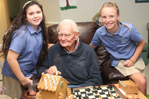 Pines resident Michael Nash gets excited about his gingerbread house made by Emily Walker and Brooke Adair.