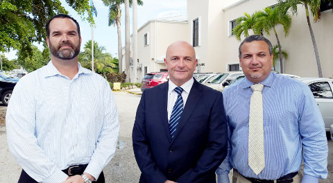 Cayman’s new fire chief, David Hails, center, with Ministry of Home Affairs Chief Officer Eric Bush, left, and Deputy Governor Franz Manderson.