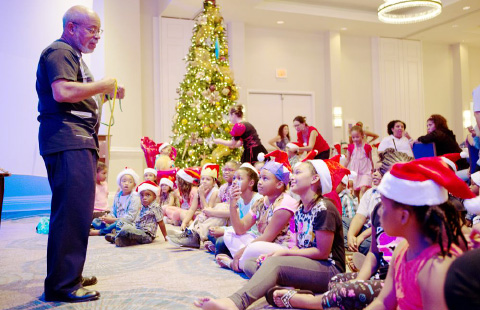 ‘The Mighty Ricardo’ dazzled children with his magic show during Rotary Central’s Christmas party. - Photos: Kelsey Jukam