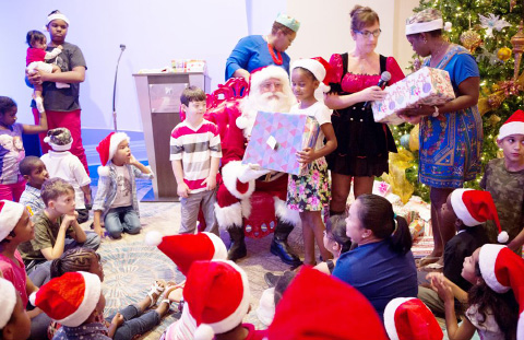 Santa and his helper gave presents to more than 70 children who attended Rotary Central