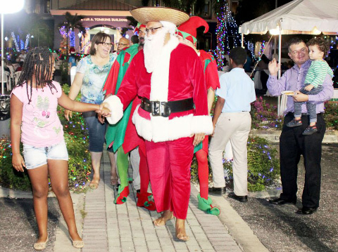 Santa welcomes visitors to Cayman National Bank’s Old Caymanian Christmas-themed event.