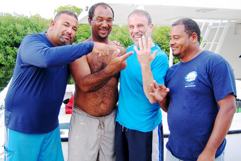 Steven Koller, second from right, with Jerry Ebanks, who found the ring. Crew members Eric Andrade, left, and Polo Nunez, right, celebrate with them.