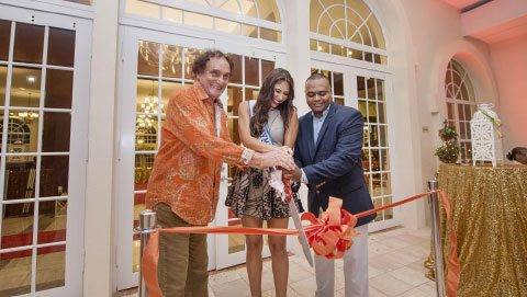 White House Board Chair Ernie Smatt, reigning Miss Cayman Tonie Chisholm and Bodden Town MLA Alva Suckoo cut the ribbon.