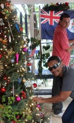 Alicemae Bodden and Emilio Watler put the finishing touches on a Christmas tree. - Photo: Jewel Levy