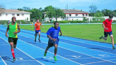 St. Ignatius’s Dante Ramoon (blue) takes the lead in the Year 9 Boys 100m.