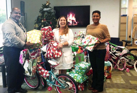 Ernesto Carter and Paulinda Mendoza-Williams with the Department of Children and Family Services receive donated items from Cayman International School teacher Ms. Rita.