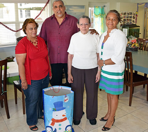 Chief Officer Dorine Whittaker and Minister Osbourne Bodden, with Pines resident Mona Banks and Pines manager Lynda Mitchell.