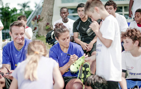 Stefano Bonati, a student at Cayman International School, gets an autograph from World Cup MVP and 2015 World Champion footballer Carli Lloyd.