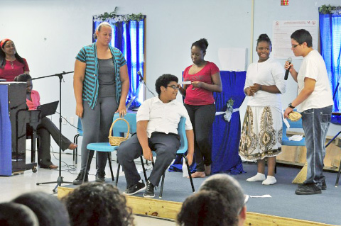 The high schoolers perform a skit.