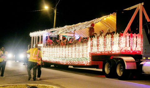 Passengers singing Christmas carols make their way through the eastern districts Tuesday night. - Photos: Jewel Levy