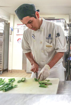 Rodrigo Bustamante, a line cook in the kitchen at Seven.